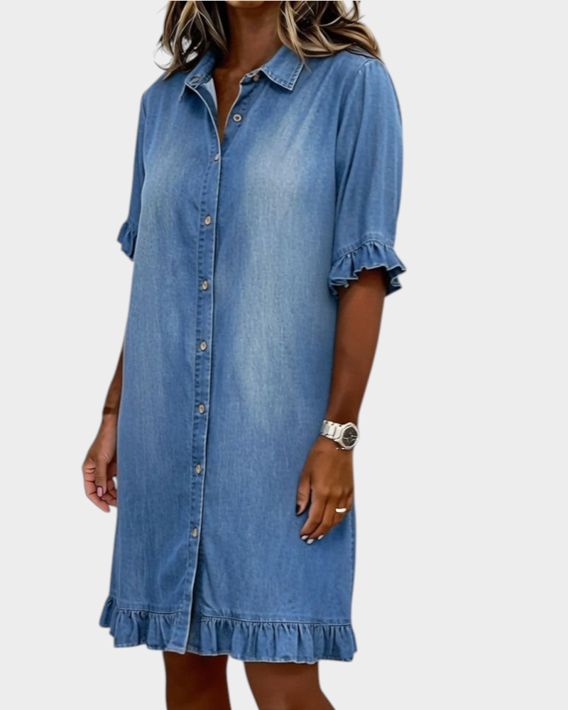 Aurore Paris blue denim shirt dress in 100% cotton with a collar, button front, and ruffled sleeves and hem.
