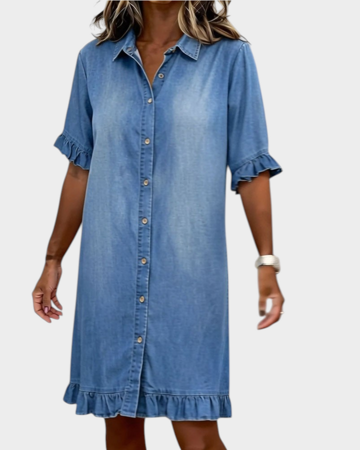 Aurore Paris blue denim shirt dress with a button-down front, ruffled sleeves, and a ruffled hemline.