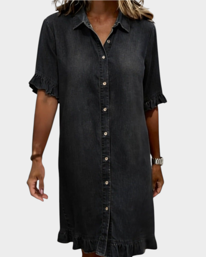 Aurore Paris charcoal grey denim shirt dress with a collar, button-down front, and ruffled sleeves and hem.