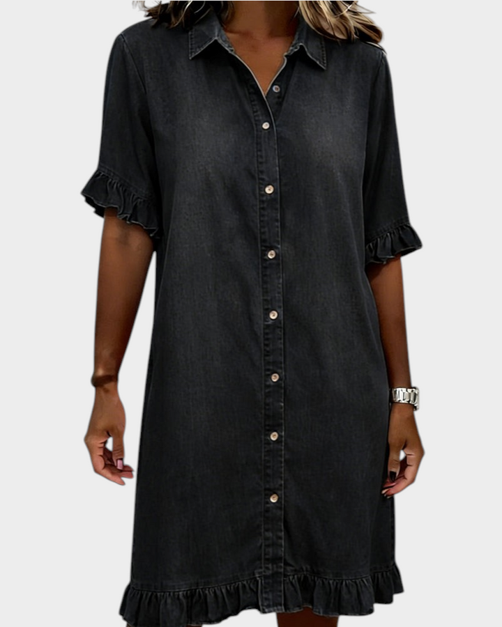 Aurore Paris charcoal grey denim shirt dress with a collar, button-down front, and ruffled sleeves and hem.