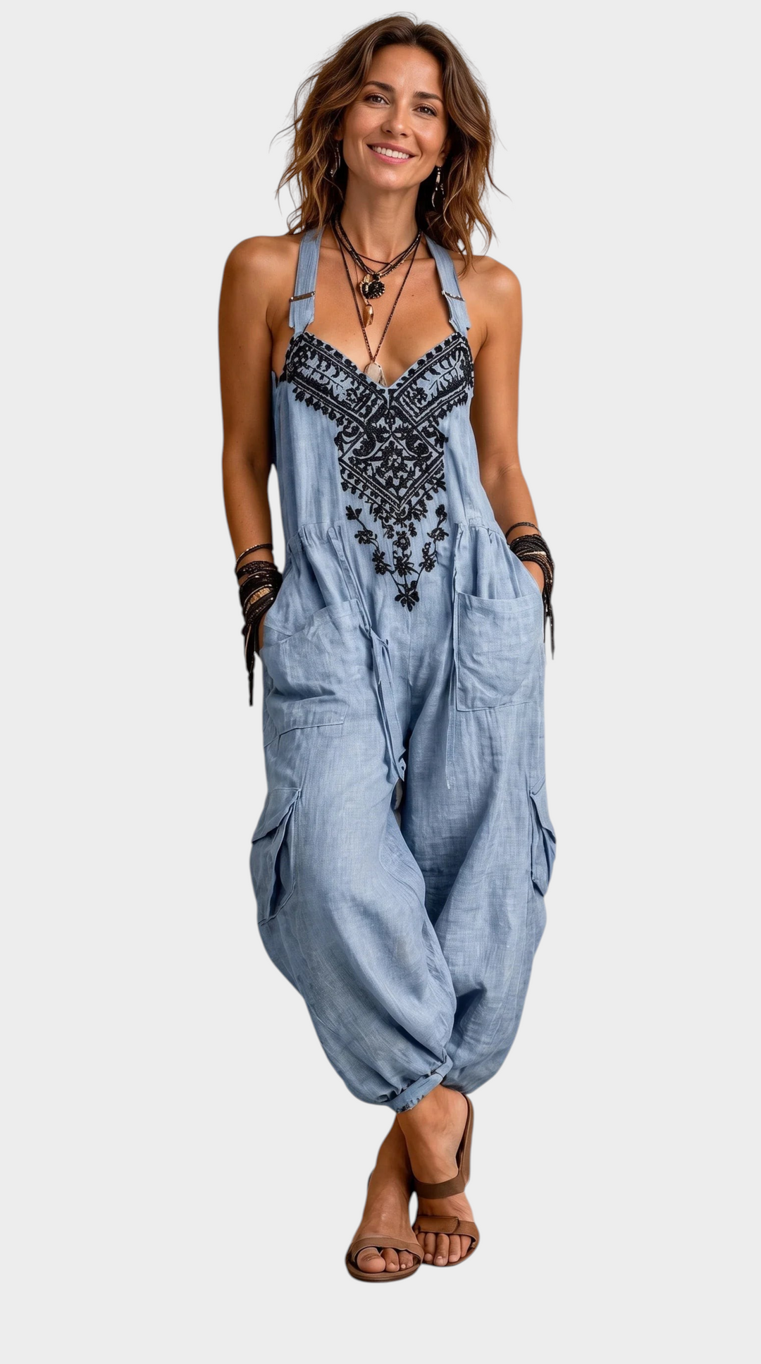 Aurore Paris Estelle bohemian light blue jumpsuit with black embroidery, adjustable straps, and large cargo pockets.