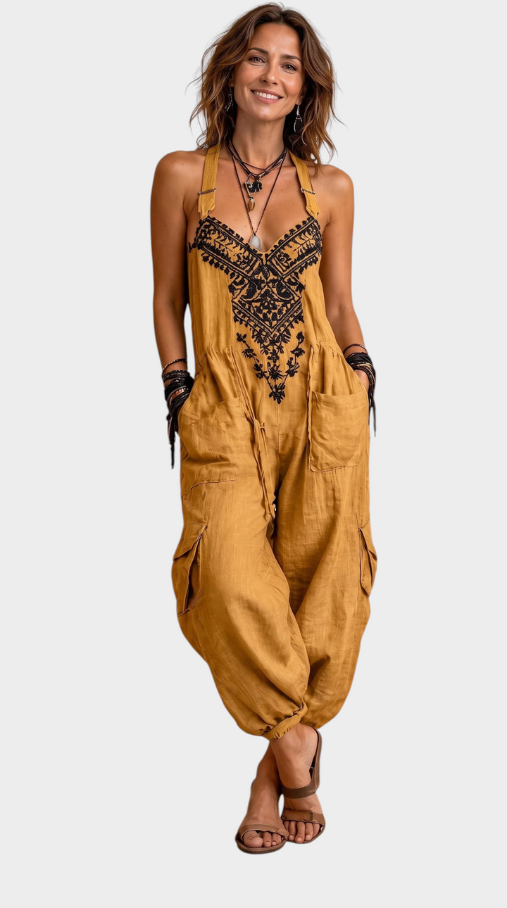 Aurore Paris Estelle bohemian mustard jumpsuit with black embroidery, adjustable straps, and side pockets on a model.