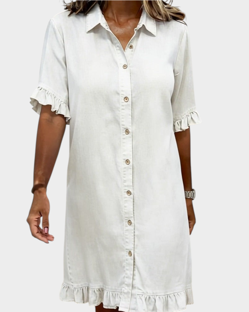 Aurore Paris white denim shirt dress with a collar, button-down front, and ruffled sleeves and hem.