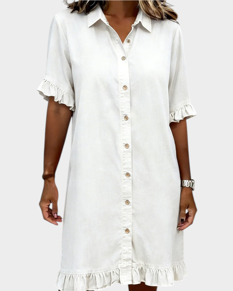 Aurore Paris white cotton denim shirt dress with a collar, button-down front, and ruffled sleeves and hem.
